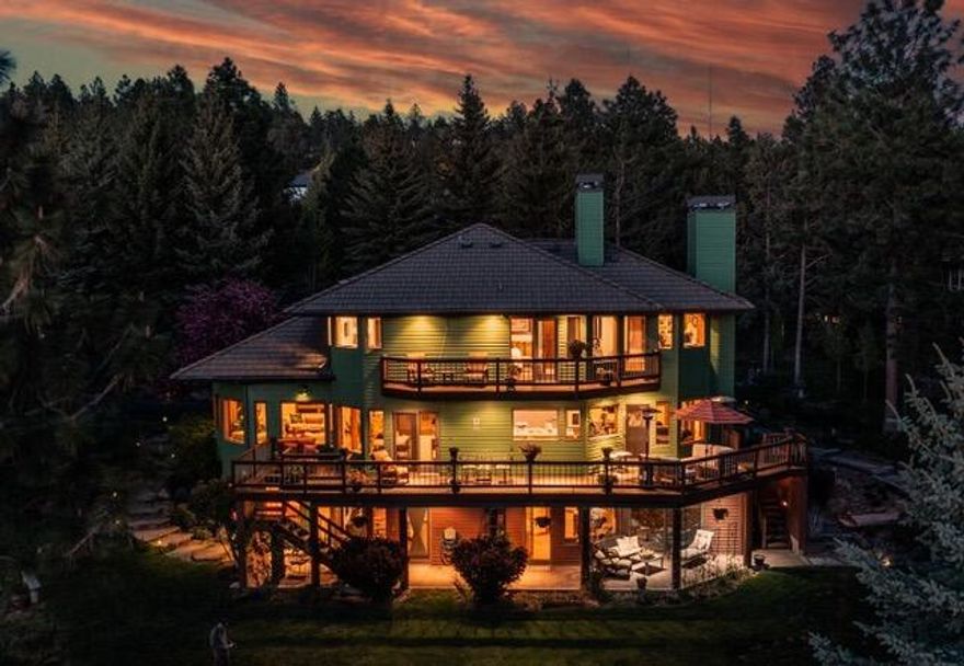 Experience breathtaking Cascade Mountain views from nearly every room in this stunning 3,960 sq. ft. Awbrey Butte home on a spacious .84-acre lot. With 4 or 5 bedrooms, 3 full + 2 half baths, and flexible living options. The main level centers around a warm family room with fireplace and bright, well-equipped kitchen with abundant storage and custom work spaces.  The primary retreat features radiant floor heat in the bathroom, a private deck, cozy wood fireplace, and a large office, that could also serve as a 5th bedroom. The downstairs living area is perfect for a private suite, guest space, or multi-generational living. Enjoy the convenience of an elevator, 2 central vac systems, in-home humidifier and a 3-car garage with epoxy floors, heat, and additional exterior flat parking. Relax in the indoor sunken hot tub with outdoor access, by the fire pit, or beside the tranquil water feature. Expansive decking, natural landscaping, and ample storage complete this exceptional property.