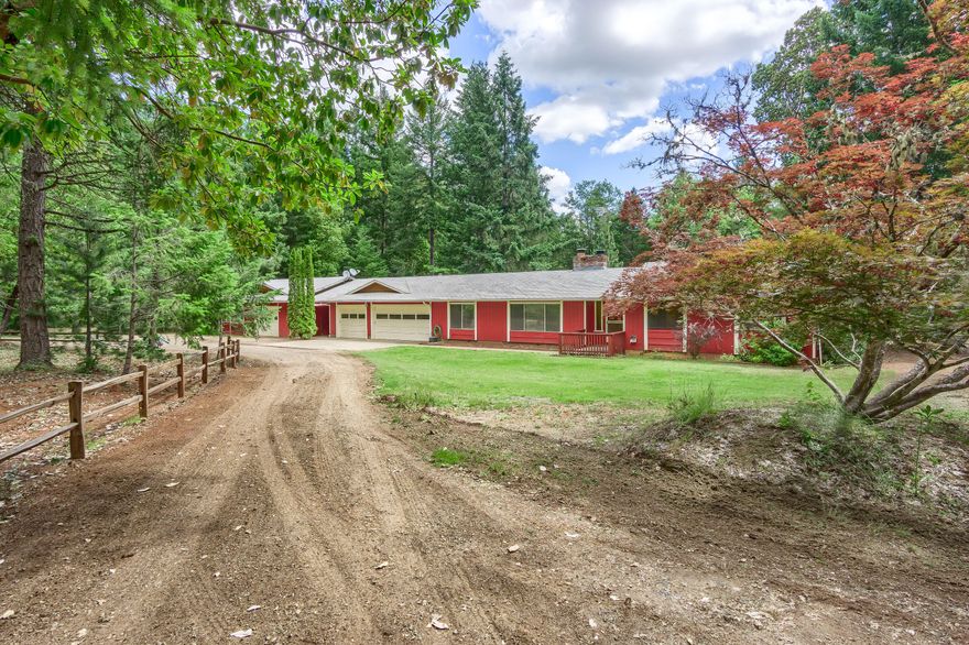 Privacy on 15 acres of level & lush forest land w/ seasonal creeks & trails. Gated entry to Ranch style single level home. 2 wood burning fireplaces, lg kitchen w/ tile counters, dbl ovens, 1 convection, 5 burner cook-top, 3 door refrige.  Family rm off kitchen w/ slider to a lg vaulted covered deck over looking the park like setting. Newer hickory wood floors in family rm & hallway. Laminate floors in bdrms & wood floors in entry, living & dining room.  Lg laundry rm w/tile floors & counters + half bath. Main bath w/tile floor, lg tile shower & tile counters. Lg master w/slider to backyard, 2 closets, master bath tile floors, counter & around the tub & shower. 3 car finished garage w/a 2nd garage/shop w/drive through garage door. Fenced garden area, fruit trees, out buildings & room for animals or a barn & marketable timber.