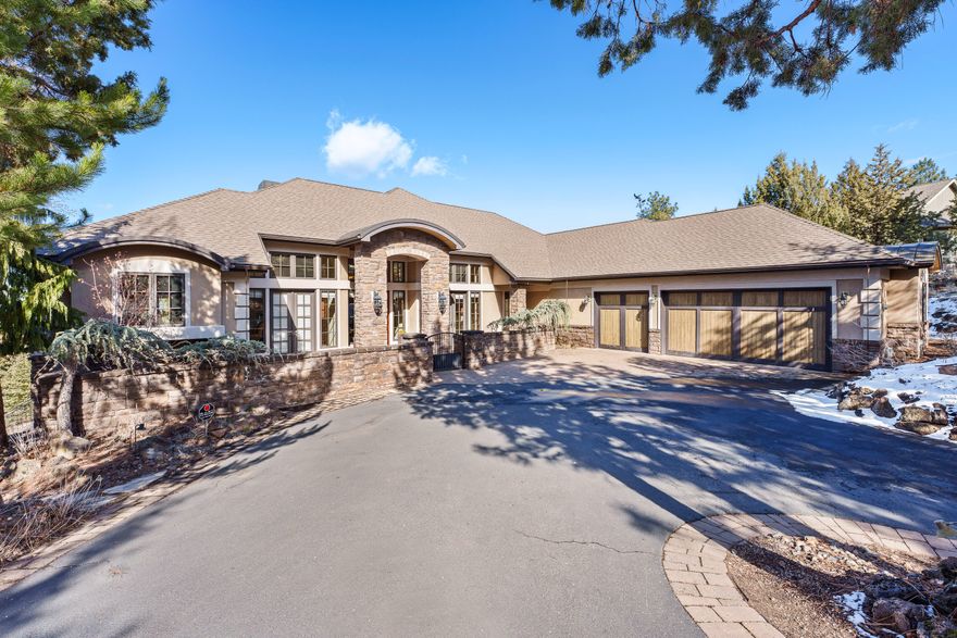 Experience the epitome of luxury in this custom-built single-level home. Be welcomed by panoramic mountain views from nearly every room. The heated floors run throughout the house, making every step a warm indulgence on those cold, winter nights. The gourmet kitchen features an oversized island and is equipped with two ovens and dishwashers, perfect for both intimate dinners and grand parties. All bedrooms are ensuite with separation from the primary and guest rooms. The large Primary suite boasts a huge custom closet - a steam shower and spa tub. Office with beautiful built -ins. The basement with separate entrance houses a wine room, plus a large area perfect for an art studio. A 3-car garage completes this home, offering ample space for your vehicles and storage. Refined living in this stunning home!