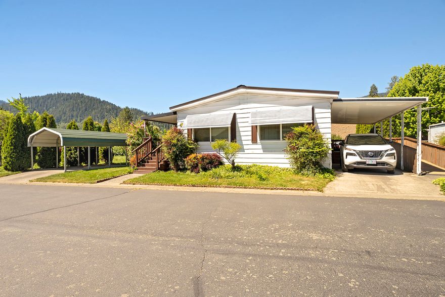 Nicely updated two-bedroom, two bathroom double wide on a large space in a pet-friendly, all ages park. This home features a large kitchen with newer appliances and breakfast bar. The spacious dining room has a wall of built-ins and desk. The laundry room is large there is a covered patio for your enjoyment. The home has a brand new metal roof as well as several updates including vinyl windows. There are two car ports and plenty of additional parking. A fully fenced yard with semi automatic drip system and mature landscaping completes the beautiful outdoors.