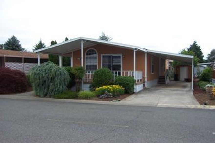 Move Right In to this immaculate 1539 Sq Ft 2bd/2ba home. Large living room, Formal Dining Room, Vaulted Ceilings, Breakfast counter in kitchen, window drapes, carpet 3 yrs old, washer & dryer, refrigerator, microwave,. Large laundry room with sink. Master bedroom has large bay window. Master bath has large garden tub and separate shower and two sinks. Front deck is 2 years old and made of Trex-decking, beautiful landscaping with sprinklers, new composition roof in 2005, 2 car attached car port with, cement driveway, Heat pump, 1 year Home Warranty. Located close to town and large park.