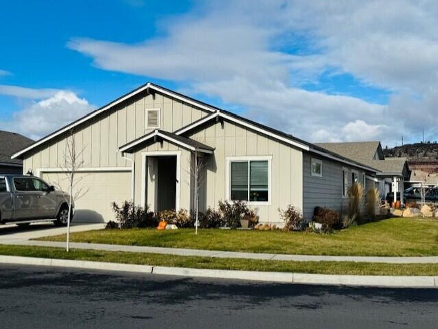 Just 2 years old, this 1,892 SF corner-lot home sits blocks from top elementary and middle schools in a lovely NW neighborhood. Sun-filled spaces greet you through abundant windows. The popular Charity floor plan with award-winning kitchen features quartz counters, stainless steel farm sink, eating bar/island with stainless steel range & hood, and the kitchen and eating area flows into a vaulted great room with cozy gas fireplace, perfect for quiet evenings or holiday gatherings. Retreat to the spacious primary suite featuring vaulted ceiling and spa-like bathroom with soaking tub, step-in shower, double vanity, and walk-in closet. A junior suite offers a lock-off option for flexibility. The third bedroom is perfect for guests or a home office. This home lives like brand new and Seller is including a one-year home warranty.