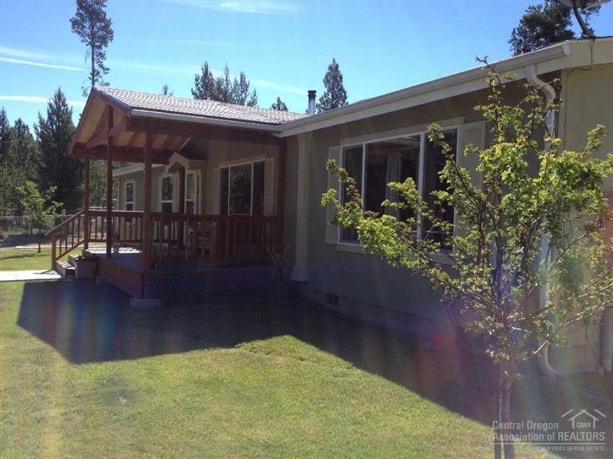 Great buy!! Almost 2 acres with the forest in your back yard and the little Deschutes river across the street. Very clean inside and out, 3 beds, 2 baths. Spacious open floor 1728 sf. Water conditioner. Property is fenced the garden area dog area fenced, Sprinkler, nice trex front porch & large trex back deck with 3 car garage with 10 ft. ceiling oversized doors 36x30, RV area, Lots of room for your toys.