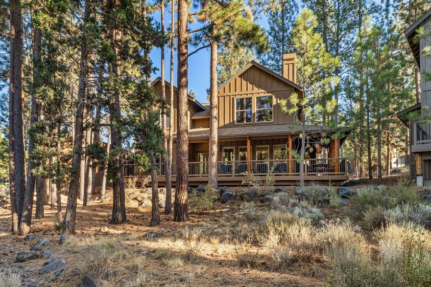 Nestled in River Wild at Mt. Bachelor Resort, this fully furnished lodge-style home is a rustic yet elegant retreat. The great room features a towering stone fireplace under cathedral ceilings, merging modern comfort with rustic charm. Two primary suites and a guest room offer luxury and versatility, ideal for full-time living, unforgettable holiday getaways, or investment as a rental property. Outside, a wrap-around porch invites BBQs, morning coffee, and mountain air. A detached garage stores outdoor gear and vehicles. A sparkling pool and spa are a short stroll away for relaxation & recreation. Whether you seek Mt. Bachelor's slopes, mountain biking on Phil's Trail, river walks, fishing on the Deschutes or enjoying Cascade Lakes, this location has it all. Short-term vacation rentals are allowed per the HOA & City of Bend, offering a lucrative opportunity to share this incredible home. Experience the ultimate mountain lifestyle in the beauty of River Wild. Your adventure begins here