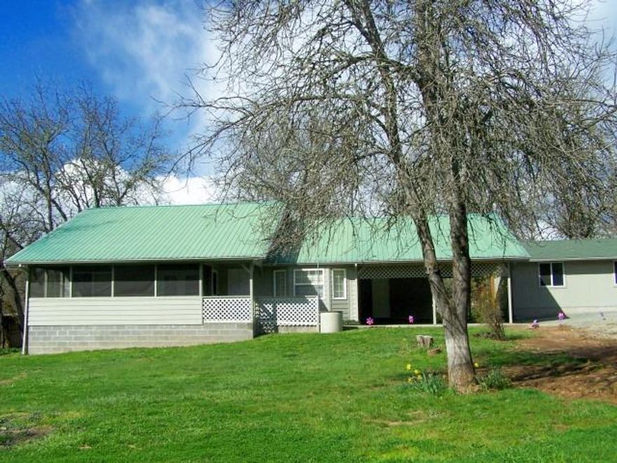 Gorgeous territorial views! Recently updated home on .52 of an acre between Grants Pass and Murphy. Solid Build with double Good Sense construction-meaning double insulation & upgraded vinyl windows, per seller. Custom built home has 3 bed/2 baths, large kitchen with dining area and vaulted ceiling in the spacious living room. Huge pantry/laundry room with utility sink offers a massive amount of storage. Home was designed for maximum use of square footage-no hallways. You can enjoy the ample and bright screened in porch year round. Well drilled in 2016 produces 100+ gpm per well log. In addition, there is 480 sq ft shop on concrete slab with lighting and cabinetry. Oversized attached carport will accommodate BIG trucks with additional storage for toys or use as patio. Easy entry with ramp to front door. Attached insulated and finished space of 130 sq ft has separate entrance-great for work shop or dry storage. RV parking with water and sewer. Plenty of parking in circular drive.