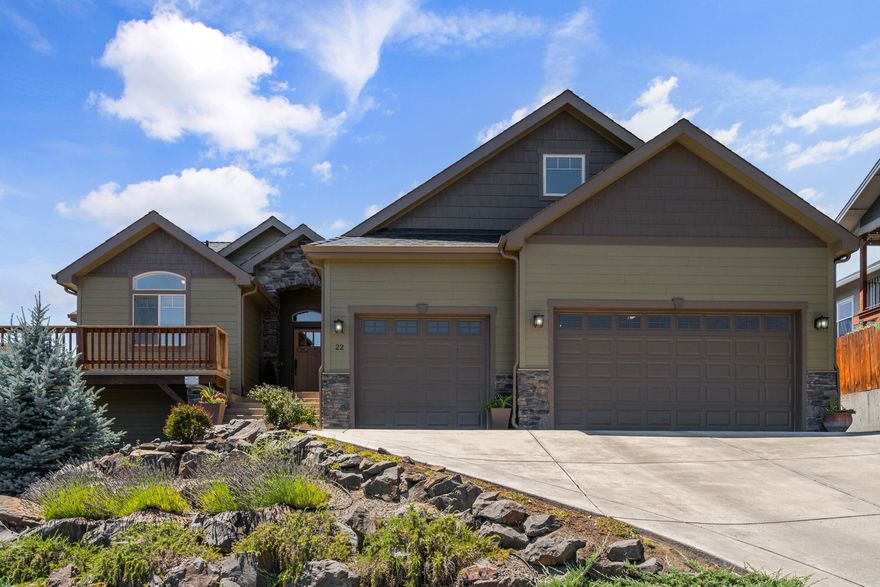 Craftsman-style home with expansive mountain views! Great room with vaulted & 9-ft ceilings, wood laminate flooring, and Alder interior doors. The island kitchen includes granite counters, stainless appliances, Knotty Alder cabinets, a walk-in pantry, and a large island with seating. Formal living and dining areas open to a wraparound covered deck, ideal for entertaining. The main level includes the primary suite with dual closets, double vanity, water closet, and tiled walk-in shower with duel heads, plus a second bedroom and full bath. The third bedroom is upstairs with a full bath, and walk-in closet, great for guests or office use. Oversized finished 3-car garage on the main level. Downstairs includes 1,000 sq ft of framed and plumbed space with separate entrance, ideal for rec room, additional suite, or storage. Recent exterior paint, refinished wood accents, tiered irrigated landscaping, RV parking with gravel pad and gate, and covered patio off the walkout basement.