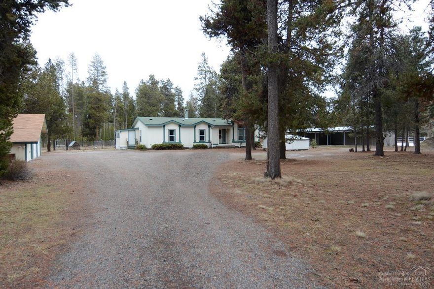 Equine estate nestled on a dead-end paved road. 2.19-acre corner lot is just minutes to Sunriver, Mt. Bachelor and the High Lakes. Borders 8 acres of common area w/direct access to the Deschutes National Forest. You will love the tranquility this property offers. Room to park your RV w/electric hookup. Detached double car garage w/separate storage attached. Barn wih 3-12X12, 1-12X16, hay storage or foaling stall, locking cedar lined tack room + 2 other outbuildings & outdoor arena. Inside the home features an open living area 4 bedrooms + office w/ built-ins. Large open kitchen, stainless appliances, mud room and so much more...