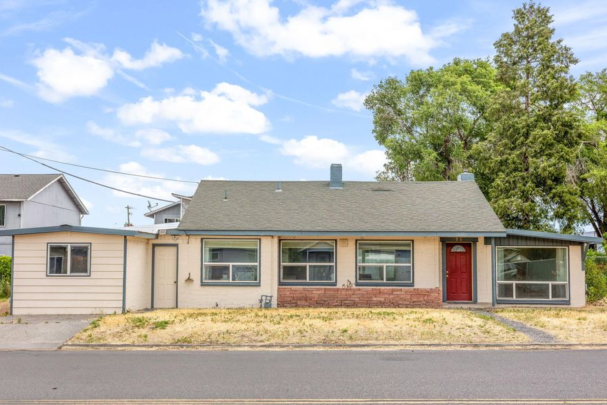 Here's an affordable home on a large double lot in Madras. This charming 2 bedroom 1 bathroom house features a bonus room and a converted garage for lots of living space. This brick home has hardwood floors, vinyl windows and some new paint inside. Enjoy the winters in front of the gas fireplace. The large utility room provides plenty of space for the washer and dryer. This home is solid and ready for your finishing touches. There is a large fenced back yard that is perfect for a garden or pets or both. There is plenty of parking space for an R/V or boat or other toys.