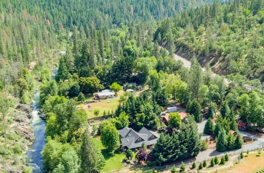 The Oregon Dream property backs BLM land overlooking the Applegate River with irrigation rights.  Park like setting! 1st time on the market with attention to detail throughout the home.  Open kitchen with quartz counters, tile floors, stainless steel appliances, dining room takes you into the large great room with floor to ceiling raised hearth fireplace. Vaulted cedar ceilings, large windows and skylights, temp controlled wine room, disappearing twelve-foot glass door to outdoor covered patio, seating area and fire pit, perfect for outdoor living. Main floor level including two primary suites. Beautiful newer master suite with vaulted ceilings, French doors to hot tub, spa-like bathroom, walk-in tile shower, soaking tub, double sinks, heated tile floors, quartz counters and large walk-in closet.
Large wrap around porch, shop, covered RV parking, garden, small vineyard and deck with views and sounds of the Applegate River. 15 min drive to J.Ville, 1 yr Home Warranty.