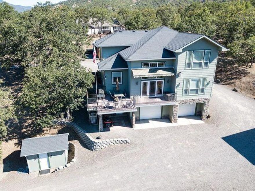 Incredible Custom Built One Owner Home in Beautiful Gold Rey Estates. Absolutely gorgeous views of Rogue River from nearly every picture window on the river side of the home. Excellent floor plan 2-story home w/modern design. PLUS huge heated 864 Sq Ft shop w/roll-up doors, finished upstairs perfect for extra hobby room, remote hoist, custom carport, & covered RV parking w/hook-ups. This home offers too many upgrades to list & situated on 2.26 acres. Custom wood details throughout. Real Hickory flooring, vaulted ceilings, custom gourmet kitchen w/walk-in pantry, ss double oven, counter-depth fridge, custom cabinets, granite countertops, more. Movie theater & oversized 2 car garage. Large master suite w/walk-in closet, jetted tub, walk-in shower & dual sinks. This house is in perfect condition. Custom landscaping w/fire pit & outside space is exceptional. Take in the views from the Appx 800 sqft Trex deck & electric awning providing shade. River access only 200 yards away. Must tour.