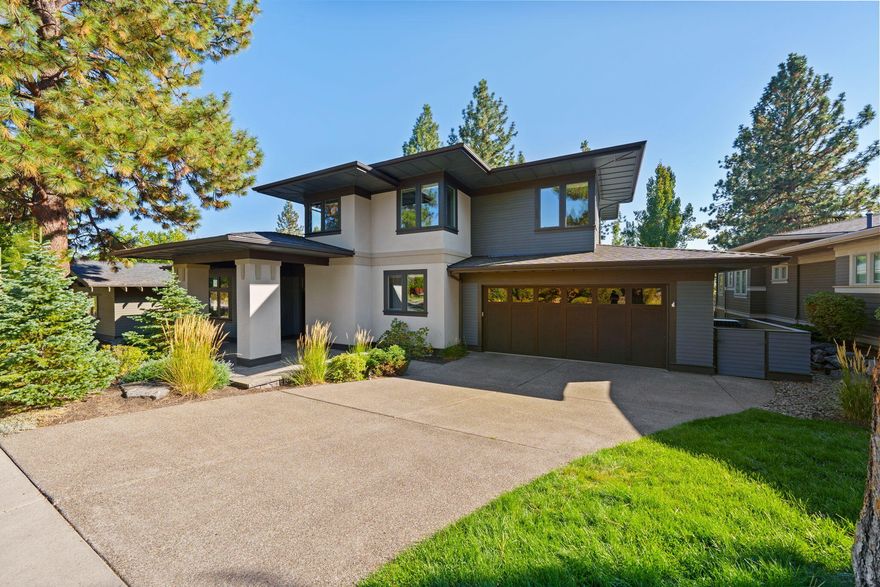 Northwest Crossing with room to roam! This contemporary, Prairie-style home sits on a private, nearly .5 acre lot. Great room has abundant windows, hardwood floors and cozy fireplace. Impressive chef's kitchen is equipped with pro-style 6-burner range, large center island, generous pantry and quartz countertops. Designed for main-level living with the primary suite and 2nd bed/bath downstairs. Primary has dual vanity, soaking tub, high-end tile shower & large closet with custom built-ins. Second floor has a lofted bonus room plus two beds and bath. Great room has abundant windows and hardwood floors. Impressive mudroom/laundry area off the oversized two-car garage. Fully fenced backyard includes terraced landscaping, accent lighting and gas firepit. The spacious deck with hot tub overlooks the rare privacy of a woodland setting! Conveniently located for easy access to Downtown Bend, the Galveston corridor, Compass Park, NWX Village, as well as easy access to the West Bend Trail system