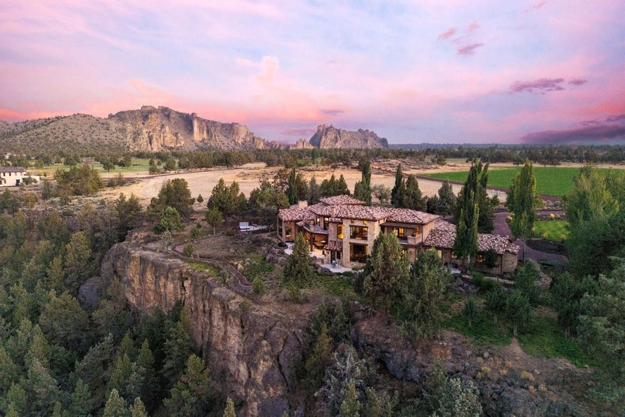 From sunrise to dusk, Smith Rock's sculpted cliffs and the Crooked River create a breathtaking backdrop for this Ranch at the Canyons residence. Designed by Norman Building & Design, the home blends refined craftsmanship with a relaxed Central Oregon spirit. Expansive windows frame panoramic views, connecting every room to the landscape. The great room, chef's kitchen, wine room, and media areas flow seamlessly for gathering, while guest suites with elevator access offer privacy and comfort. Outdoor living shines with patios for dining, a fireplace, built-in BBQ, hot tub, and lap pool. Because Ranch at the Canyons operates as a working ranch, property taxes remain significantly lower than comparable luxury properties. Expert HOA management preserves the landscape, amenities, and long-term value of this extraordinary community, just minutes from Redmond Airport and Bend.