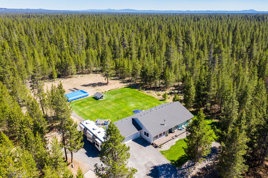 You won't want to miss this stunning home on 27 forested acres in La Pine. Enjoy the peace and quiet in this pristine 1920 square foot home with 4 bedrooms and 2 baths, as well as 2 car garage and shed. Step inside to an open, airy great room with vaulted ceilings, Hardwood floors and wood stove to cozy up on those cold winter nights. With stainless steel appliances, beautiful white cabinets, solid surface countertops, and French doors, the light, spacious kitchen and dining area are perfect for entertaining. The comfortable master suite features a walk in closet and en-suite bath. Large windows throughout the house to watch the elk, deer and other wildlife on this gorgeous property! From the immaculate interior to the beautiful backyard with deck for summer bbq's, every inch of this home is well thought out and cared for. With 27.37 acres, you'll have endless possibilities to make this dream home your own! Property MAY BE subdividable for 2nd dwelling. Ask your agent for more info!