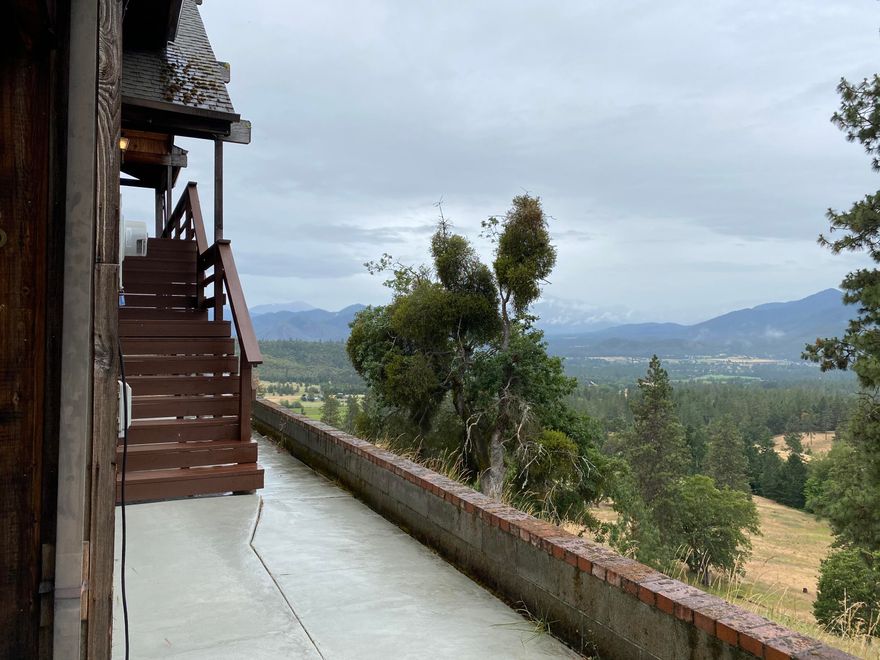 Located in the Heart of the Applegate Valley, on 20 lightly treed acres, sits this 2450 sq. ft 2-Story home with fabulous views from every window. Don't let the steep driveway scare you. Built in the mid 1980's this home is solidly built and is a diamond in the rough, and ready for your creativity. The master bedroom is upstairs, with two guest bedrooms downstairs. Kitchen has tile counters, black appliances, informal dining area, is located up stairs along with the living room with brick fireplace. Downstairs is a family room, with corner brick hearth, wet bar, and bonus room. Two car carport is attached to home, drive way is paved the last 1/4 mile, and property is zoned EFU.