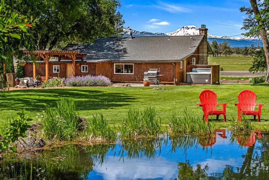 A Tumalo Oasis.  Nestled in a grove of trees with mature landscaping and a huge 7 peak mountain views this small acreage will allow you to escape the bustle of town.   Built in 1910 and updated by a master home builder every aspect of the property has been thought out.   The home's interior feels European, fresh but established.  The approx 1300 sqft RV shop has 200 amp power, propane heat, amazing natural light and pull through garage doors.  Attached to the shop is a 1 bedroom ADU perfect for guests or a home office. There is also a separate 800 sqft 3 car garage with heated floors and tons of storage.   The property hosts a pond with willows, multiple garden beds, and room for chickens or small animals.  This is a special piece of land with thoughtful improvements.