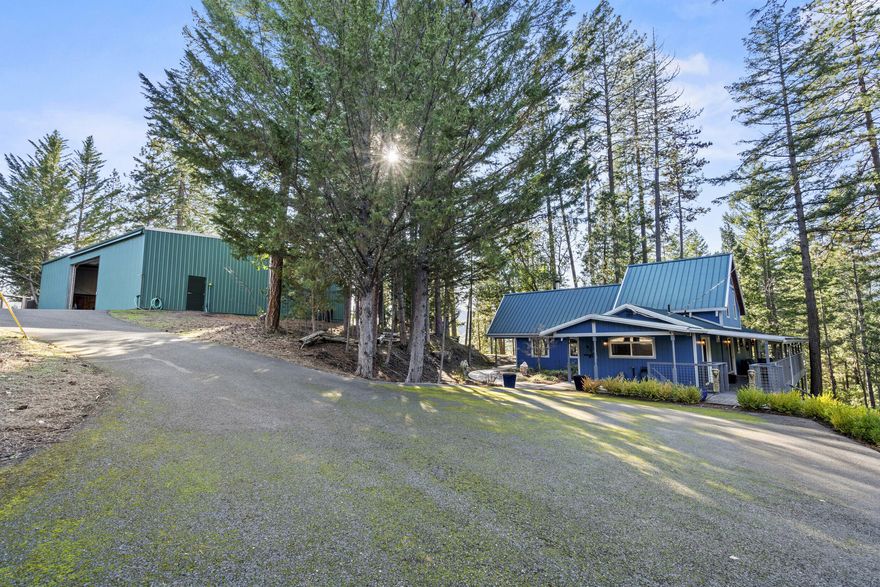 A truly one-of-a-kind property close to being off grid with a 4 bedroom, 3 bath home, a gigantic SHOP/ garage/ RV garage w/ heat, air, bathroom, gym & a new metal roof July 2024. This stunning property is nestled next to a privately owned LAKE, features raised garden beds w/ a greenhouse, multiple large sheds & animal quarters, multiple paddocks, round pen, VIEWS galore, two 1100-gal water catchment, a seasonal creek runs the width of the property, numerous HORSE/ quad trails, & so much more, all on 18+ ACRES of wooded land providing you immense privacy. The home features a grand living room w/ vaulted, wood ceiling, large, picturesque windows. The kitchen was fully renovated in 2020 w/ Viking appliances, a gas range w/ dual ovens, soapstone countertops, & a farm style copper sink. The main level master has a roll in shower, jetted tub, & fireplace w/ access to the back patio. 20 minutes to Medford, the airport, 30 minutes to Grants Pass. This property shows pride of ownership!