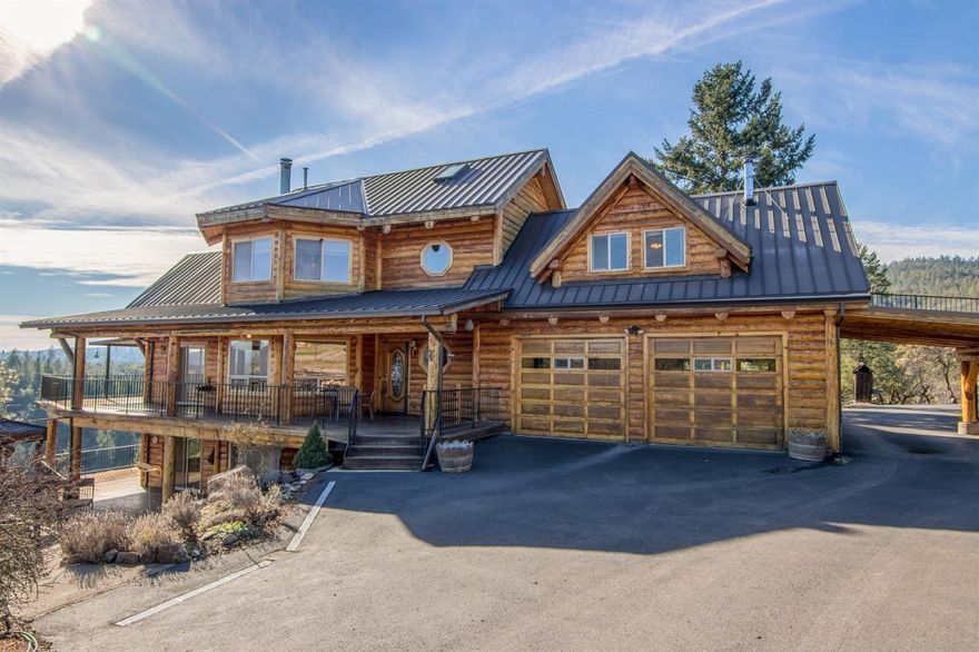 Enjoy 20-Acres of total privacy with views of the Rogue River and valley below. This Three-story French Canadian Timber frame style home with basement offers a modern rustic interior featuring 3 bedrooms, 2 bathrooms, 1-half bathroom, 3,296 sq. ft. The Master Bedroom offers an abundance of natural light & a walk-in closet. The Master Bath features a large soaking tub & walk-in shower. The open kitchen offers a large island, adjacent dining room is adorned with a floor to ceiling rock wall fireplace & an abundance of cabinet space. The main floor offers a large living room with vaulted ceilings & a wall of windows overlooking the River & Mountains. The lower level features a full wet bar, second living area & the 3rd bedroom. Over 1200 sq ft of covered Trex decking, BBQ pit, smoker, hot tub, 857 sq. ft. front porch. The home also offers an attached 2-car garage, RV parking, 30x36-shop, 1,080 sq. ft. pole barn, storage shed, zoned WR. Fuel reduction was done on the entire property.