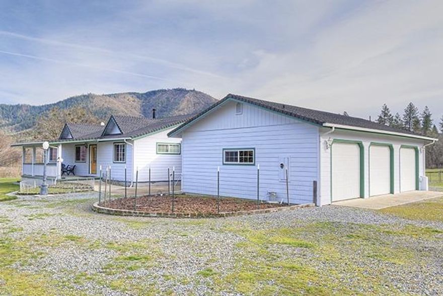 Incredibly Well-Kept 1,924 Sq Ft, 3 Bed, 2 Bath Single-Level Home on 5 Acres in Williams! Newer Home built in 2003, that looks like it could have been built yesterday. This Home offers a Comfortable and Welcoming Open Great Room Design, a Beautiful Country Kitchen, Large Laundry Room with Cabinetry, plus a Separate Office that could readily be used as a 4th Bedroom! Lovely Master Suite with Dual Vanities, Jetted Tub, and Separate Shower. Sit and enjoy the Peacefulness of the Valley on the Covered Front Porch, and bring your world Outside onto the Huge Rear Screened Patio. Parking includes a Finished Three-Car Garage and Carport. The Fantastic 40' x 30' Finished and Heated Shop offers a High Door, and two matching 40 x 10 Covered Eaves on each side! Several other nice Outbuildings offer additional Storage. The Property here is Fully Fenced and Cross-Fenced, Gated, and absolutely Level and Useable. Lots of Open Pasture, Established Fruit Trees, and Pretty Mountain Views. Picture Perfect!