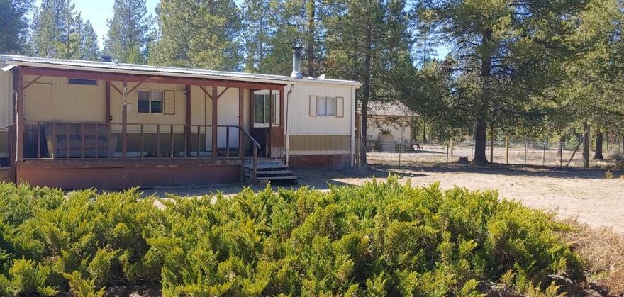 Live in while you build your dream home. Nicely treed lot. Two outbuildings, with wood wood storage. New well. Updated electrical panel. New carpet in bedrooms. New laminate flooring in kitchen and living room. New plumbing through-out the home.