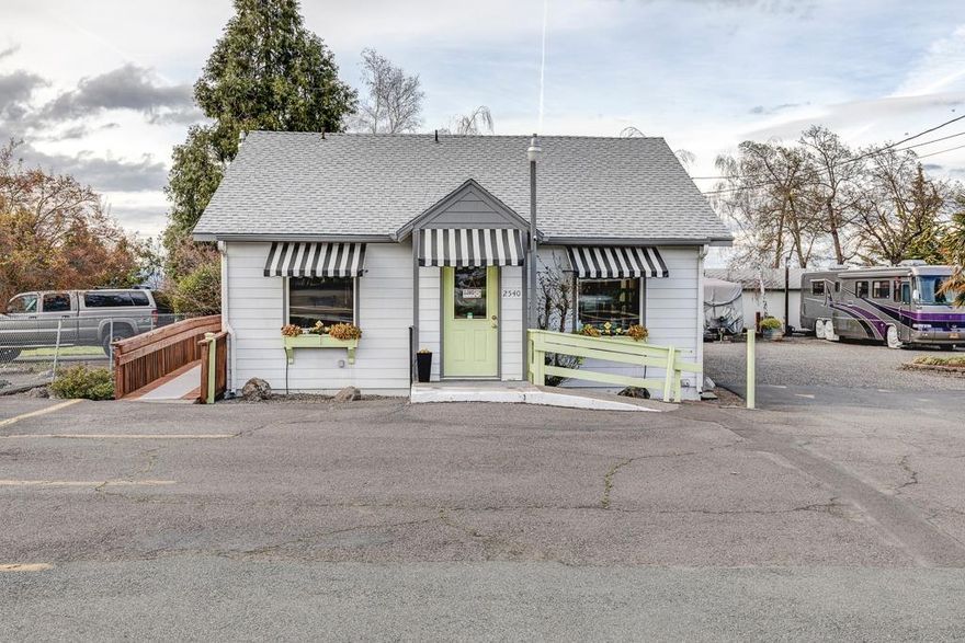 Ever dream of living and working on the same property? This is YOUR OPPORTUNITY to run your business from a wonderful 1200 sq ft retail space facing busy Main St. and live in a spacious and recently updated 1918 sq ft triple wide mobile home complete with relaxing porches, lovely gardens, & a swimming pool! The retail space has been updated and is used as a hair and nail salon with 7 stations and a large retail area that generates about $2,100 monthly income for the owners. The retail business includes all existing inventory and fixtures and equipment. The home features a 3 bed / 2 bath split floorplan highlighted by bright and open spaces, new kitchen & bath counters & new flooring in much of the home, vaulted ceilings, skylights, and ample storage. In addition, there is 2-car garage, RV parking and hook-ups, plenty of parking and outdoor space. Home and business being sold as a package. Call today for more information. Owner-carry options available.