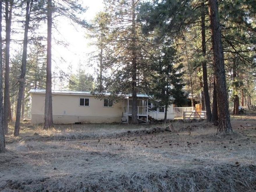 Keno- 1976 Double wide MF with Nice Metal Roof on 1 Acre in the Pines. Has septic & well it shares with uphill neighbor.Forced air natural gas heat. Needs new power pole & meter, appliances and cosmetic fixing. Being sold as is. Cash only.