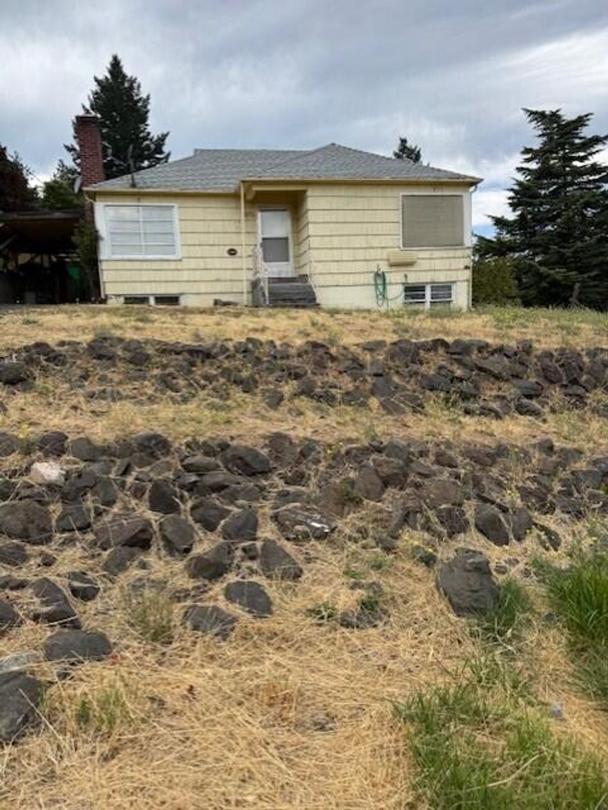 Come tour this charming cottage perched above the town. Two bed single bath on large .32 acre lot. Built in 1948 and has been in the same family since. Hardwood floors in living area. Finished basement with concrete floors has laundry room plus a shop area with modern gas forced air heat system. Buyer to do due diligence to determine best use for property. Large back yard behind home is ready for your vision.