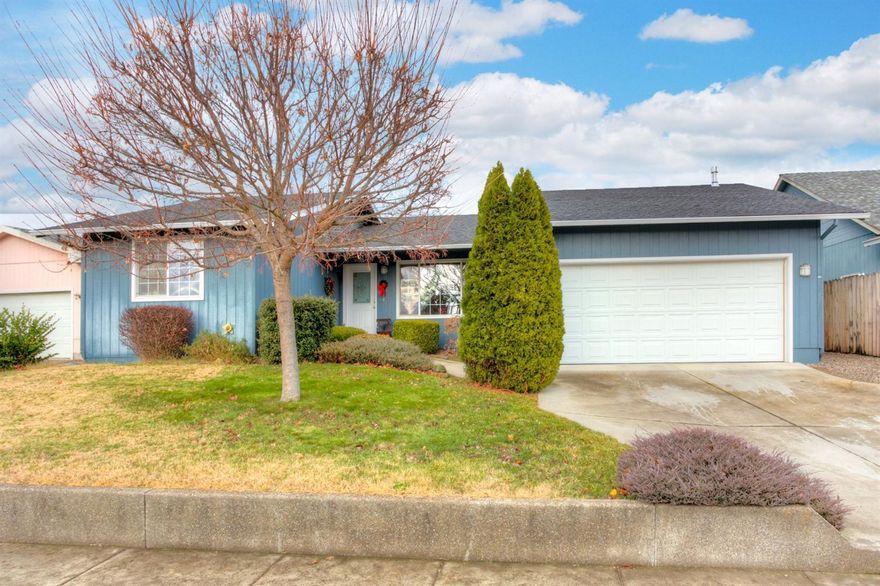 Lovely, well maintained home on a terrific street in Eagle Point. Great open floor plan with kitchen flowing into the dining and living rooms. Living room has vaulted ceiling, a large window for natural light and a ceiling fan. Split floor plan with master and bath on one side and the other two bedrooms and bath on the other side. Kitchen has lots of wood cabinets and black appliances. Dining area is next to the kitchen and has a glass sliding door to the outside. The master bedroom is large with French doors to the rear yard and a wall of closets. The master bath has a 5ft. walk in shower and a big cabinet for extra storage. The other bedrooms are perfect for guests or children. The front yard has a decorative concrete retaining wall and a beautiful evergreen near the house. Handicap ramp in the two car garage which has extra room and nice shelving. Attractive rear yard, fully fenced for pets or kids.