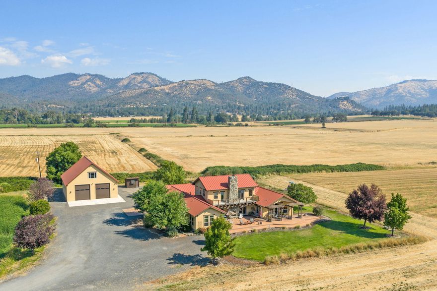 Beautiful unique opportunity in Applegate Valley with 2 homes just under 80 acres with Applegate River irrigation rights.  Fenced and crossed fenced. Lg shop, RV garage with unfinished studio above. 75X100 pole barn and year round pond.  Spanish custom home stucco exterior w/gourmet kitchen w/granite counters & tile floors, lg ceilings & windows. Lg great rm w/floor to ceiling stone fireplace. French doors to lg stamped patios. 2nd home is cute cabin w/lg covered porch, 2 bdrms, 1 bath w/wood pellet stove.  This premier Ranch is one of the most beautiful properties located across from Cantrell Buckley Park entrance w/gorgeous views of the surrounding Mts and Southern Oregon wineries.