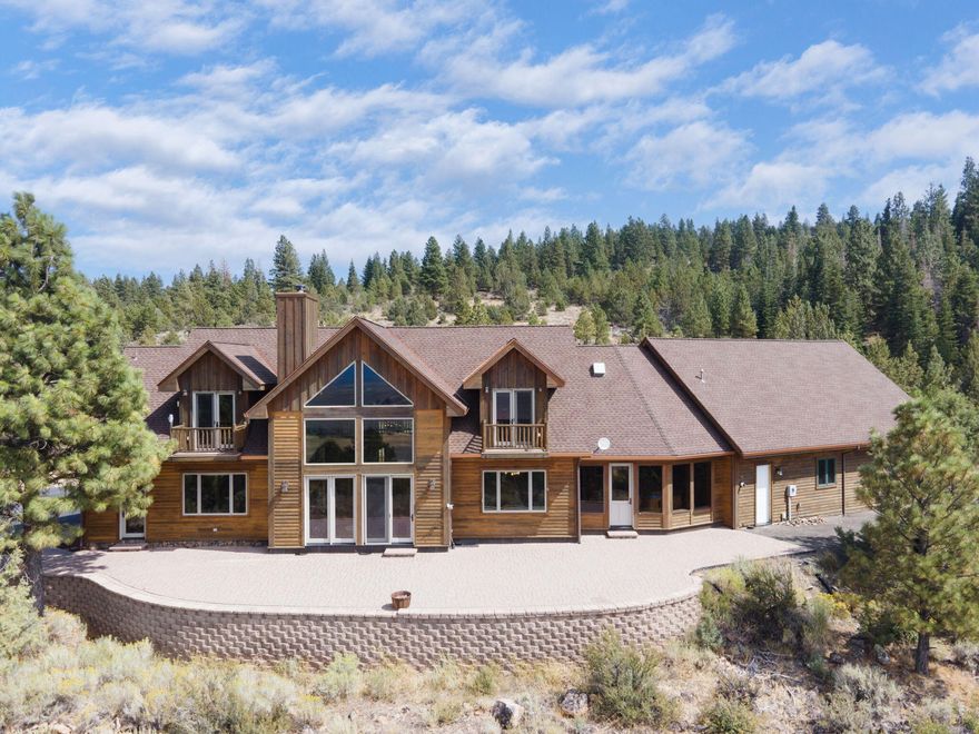 Embrace the resort lifestyle. Every day feels like vacation on your private 229 wooded acres. Approaching this magnificent 3,594sf estate, you'll be captivated by the awe-inspiring views of the valley and majestic mountains. Step inside, feast your eyes on the grand 2 story windows, boundless detail, cherry wood floors/Cedar ceiling. Feel the heated floors under your feet the entire main level-even the 1,400sf 3 car garage! Primary bedroom w/spacious en suite exudes sophistication. Adjacent office,built in desk/storage & murphy bed w/glass door to patio. The Great Room welcomes you with its grandeur/magnificent rock chimney while the Chefs kitchen is a masterpiece with eat in, live edge bar, granite, Wolf stove, double ovens, Hickory cabinets/ large pantry. Relax & enjoy the views from the Hot Tub room. Upstairs: 2 large guestrms/lux bathrm w/ Italian heated marble floor. EACH with its own walk out balcony. Hunt Elk&Deer w/Land Owner Preference Tags. Ski resort & Fishing minutes away.