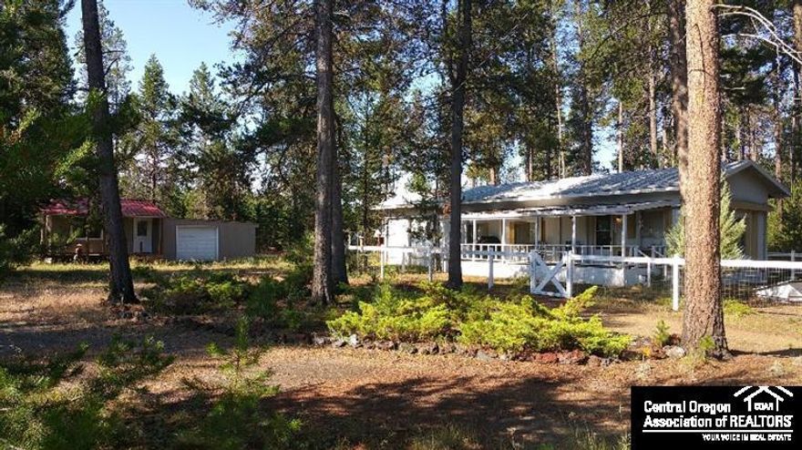 Snow Birds! This is a wonderful property for you! Located just off 6th street in La Pine. Features of this property are: RV parking, guest quarters attached to the single over sized garage, kitchenette in guest quarters, full RV hook up with 100 amp service, property is backed by BLM land. Small section around home has been fenced in for a small animal. There is a cover over the top of the home. Metal roof on guest quarters. New standard septic installed! Being sold as is.
