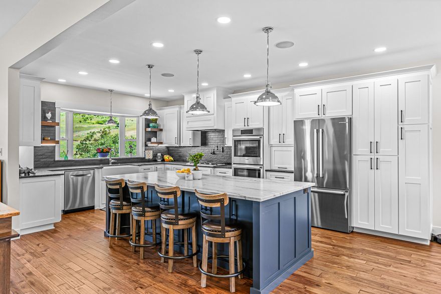 Nestled in the hills of East Medford, this 2021-built home offers the perfect blend of modern luxury & thoughtful craftsmanship. The main living space has an open-concept floor plan, tall ceilings, & windows that flood the space with light. The kitchen features a massive island with honed quartzite, complemented by leathered granite; & is equipped with high end Bosch appliances, drawer microwave, gas range, a pot filler, pull-outs & appliance garages. Smart home technology adds convenience, with voice activated light switches & built-in speakers, making it easy to control ambiance from anywhere in the home. The luxurious primary bath offers heated tile floors, soaking tub, and huge walk in shower. Enjoy breathtaking views of the valley from the Trex decks, ideal for relaxing or hosting outdoor gatherings. The home also features both upper and lower two-car garages, providing ample storage and workspace, plus more unfinished storage space! See attached features sheet for more info!