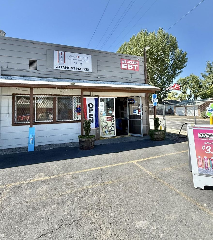 BUSINESS OPPORTUNITY! Altamont Market is a thriving business with 4.3% cap rate. Includes an attached 1 bedroom, 1 bathroom residential unit, great for either additional income to maximize your investment, or to be occupied by owner/manager. It is located on the corner of a high traffic intersection, and in a residential area for easy access. Close proximity to a school and other commercial properties. Deli area with 3 wash stainless steel sink, hand washing sink and prep area. There is parking area in the front and spacious yard off the residential side, including 4 locking sealed storage sheds. Additional gated/paved parking behind the store. Tons of updates and potential! Sale includes real estate property, business, and equipment. P&L and equipment list available. Call to book your viewing today!