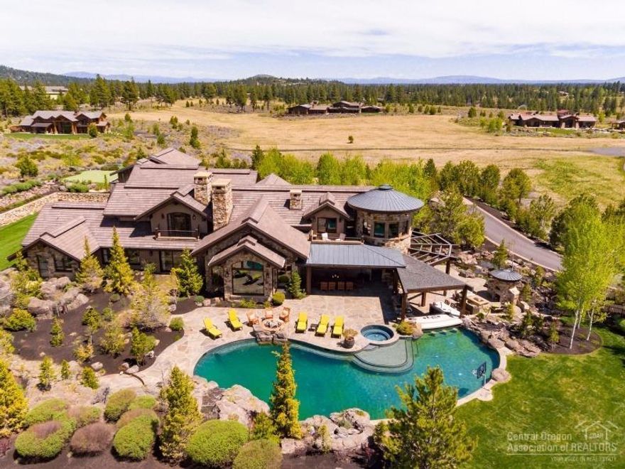 Janet Jarvis designed NW style estate in gated community; extraordinary finishes & 4 stories of custom interior design. Exquisite home features living rm w/soaring beams & FP, great rm, loft w/guest suite & sitting rm, 2.5 utility rms, den/office, brkfst nook, formal dining & temp controlled wine rm. Indoor half-court basketball court, pool, 2 hot tubs, full turf sport court, putting green & water features. Attached 4 car & detached 3 car garage. Enjoy expansive Cascade Mtn Views.