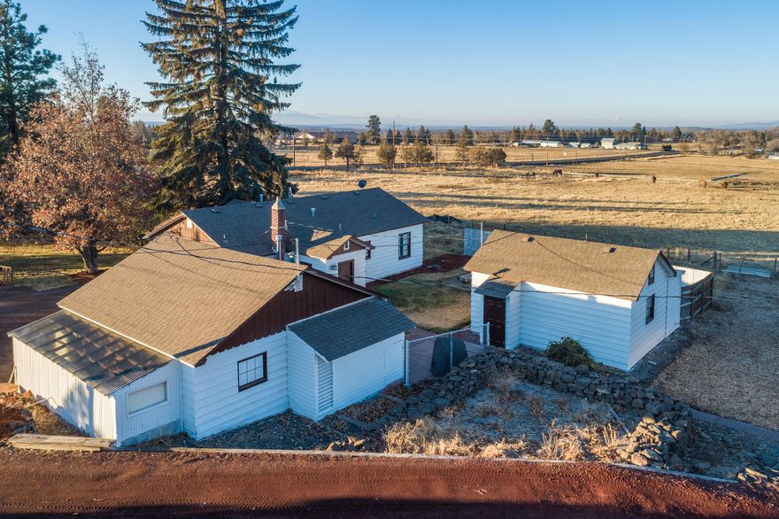 Perfect opportunity for a long term investment on the edge of Redmond! Situated in the path of development, this horse property has a lot to offer. Main home is 1103 sf & was recently updated w/new bathroom, refinished walls, floors & much more. Quaint kitchen w/all the necessities with an authentic ranch house feel. Bunk house is a 1 bedroom, 1 bath home & is a perfect guest house or place for extended family. Endless storage on this property in addition to agricultural buildings, barns & rustic stone sauna. Private well, 7 acres of COID flood irrigation in the pasture. New orchard grass planting is well established & high producing. Screened sand riding arena, corrals, open covered stalls & frost free valves conveniently placed around property. Bunk house is not included in square footage. Located just north of the new Dry Canyon subdivision in NW Redmond, near miles of paved trails & amenities are just minutes away. Bring all offers!