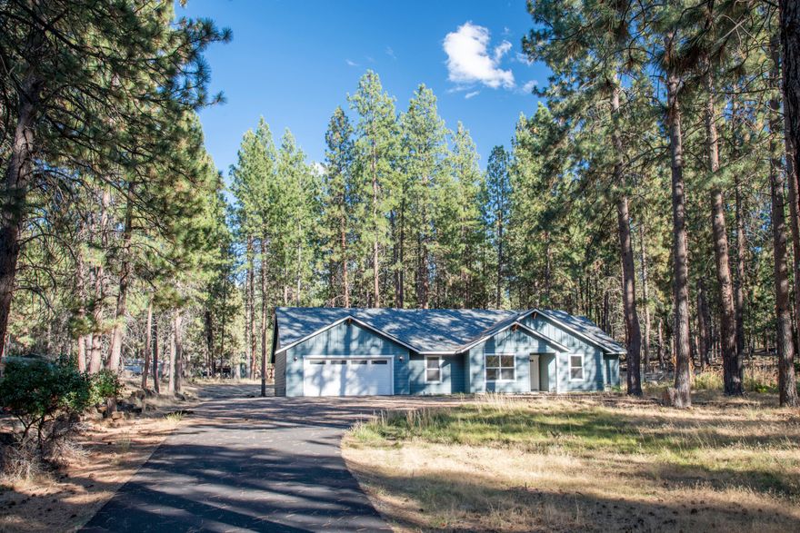 This nearly new, single-level home offers 1,952 sq. ft. of well-designed living space on a full acre in a peaceful neighborhood. Designed with comfort and functionality in mind, the open-concept living area is enhanced by vaulted ceilings, creating a bright and airy feel. The spacious primary suite serves as a private retreat with a generous bathroom featuring a soaking tub, separate walk-in shower, and walk-in closet. An office plus 2 additional bedrooms provide versatile space for guests, a home office, or hobbies. The expansive lot allows ample room for RV parking, a boat, or other recreational toys, while the outdoor setting ensures privacy and a natural buffer from neighbors. A tandem three-car garage adds even more flexibility, perfect for a workshop or extra storage.