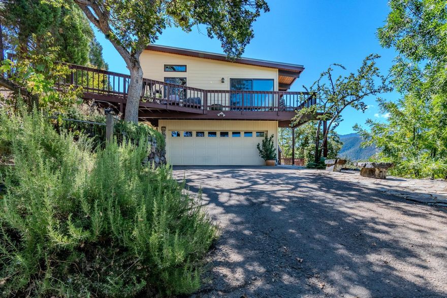 Brand New HIGH FIRE RATED ROOF. Home is centrally located between Ashland and Medford. Panoramic views of Wagner Creek Valley are the highlight from all 14 acres of this peaceful property. The main level has open kitchen, dining and living room with view window walls and vaulted tongue 
& groove ceiling with skylights. The master bedroom, also with spectacular views, is large and bright. The downstairs is flexible with one very large bedroom w/ connected private deck that can be accessed from the outside, second bedroom, office and bath. Outside amenities include a newly added artist studio with vaulted ceiling and beautiful view windows, 3 kilowatt solar electric system, TID irrigation for 2.6 acres, terraced garden w/9 organic raised beds and drip irrigation connected to holding tank, whole home propane generator, 250 gallon propane tank and chicken coop/garden shed. This house is a must see!