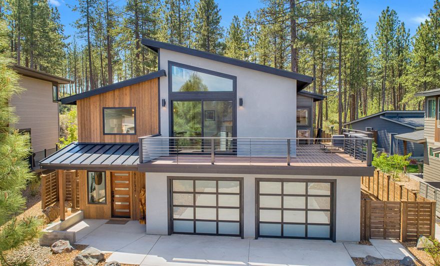 An unbeatable westside location is just the beginning of what you'll love about this stunning home located in the Bachelor View area of Bend. The light-filled open concept living area boasts a modern and stylish aesthetic while taking full advantage of exceptional views of the surrounding area.  Anchored by a spacious and well-designed kitchen that features an oversized center island, abundant cabinetry and stainless steel appliances, the greatroom flows seamlessly to a gathering space with gas fireplace and beyond to the wraparound deck, perfect for meals under the stars. The primary suite enjoys its own private deck and a beautifully curated bathroom with modern fixtures, dual vanity, large soaking tub & full tile walk-in shower. Two more bedrooms, full bathroom & tile dog wash station provide all the amenities you'll need. Located right next to the extensive westside trail system & just a 20 minute drive from Mt. Bachelor, this home is the perfect basecamp for your next adventure.