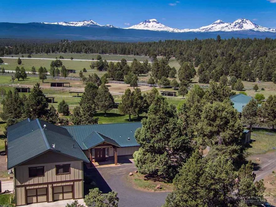 This incredibly rare property provides numerous options starting with the perfect alpaca farm to a horse facility or family compound. The house is beautiful with floor-to-ceiling windows facing the Cascade Mountains and offers two master suites with private entrances plus living quarters upstairs. High efficiency solar design with energy block construction provides low heat/cool costs. Property features include 52.8 acres, 20.5 acres of irrigation from the well, fenced/cross-fenced pastures, with loafing sheds, that are watered by a turn-key computer-controlled underground irrigation system, a large fenced-in pond, two 864 SF equipment buildings, plus available land to build round pens or arenas. The barn has stalls & guest quarters that could work as a conference space or meeting rooms. Located between Bend & Sisters, this property offers ease of operation as a working farm or sheer privacy as a retreat. Adjacent to hundreds of acres of BLM/ public lands, horse lovers can ride forever