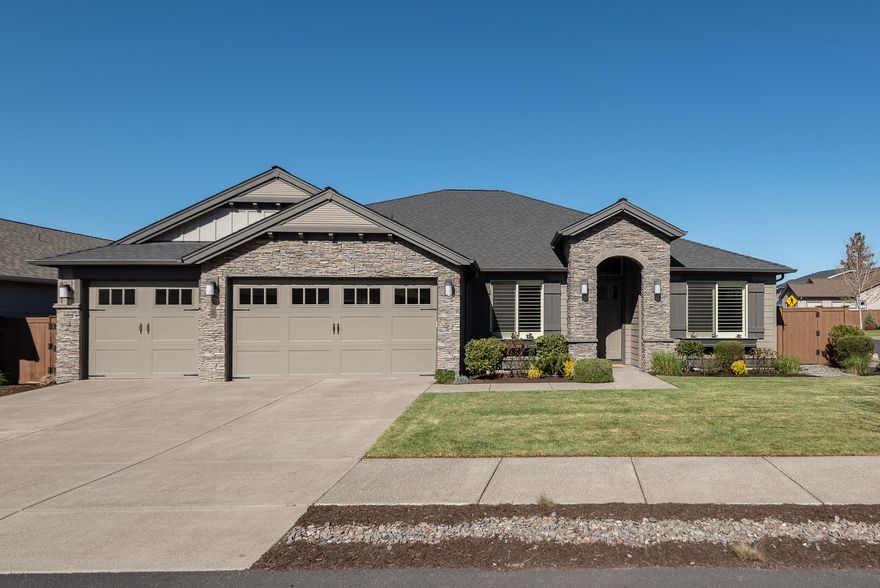 Stunning single level home situated on a .18 acre corner lot located in The Bridges. Meticulously designed, former model home features an open floor plan, office/den, dining room w/built-in buffet, vaulted ceilings, hardwood flooring, gas fireplace, custom cabinetry with accent lighting. Chef's kitchen showcases a spacious island, SS appliances, breakfast nook, and pantry. Primary suite offers coffered ceilings wood shutters, duel vanities, soaking tub, tiled shower and California closets. Two additional bedrooms, one bedroom is an en suite, offer privacy and separation from the primary suite.  Beautifully designed backyard features hand selected flowers and shrubby, paver patios and paths, gas firepit and a covered patio. 3 car garage. Community amenities include a pool, fitness center, clubhouse, indoor sports court, playground, and walking paths. Prime location near schools and the 37 acre Alpenglow Park.