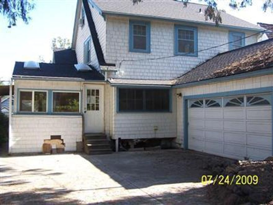 Price REDUCED! This classic vintage home is why Old East Medford is such a desirable place to live. This home features hardwood flooring, a warm paneled living rm w/cozy fireplace, sunroom, cute kitchen w/tiled counter tops, and plenty of additional living space to enjoy on the 2nd and 3rd floor. There's also a 2 car garage for your horse and carriage! There's a bit of cosmetic TLC this home needs including elect, drywall, paint and carpet so check this home out for yourself. Bank owned, take a look and make your offer today!
