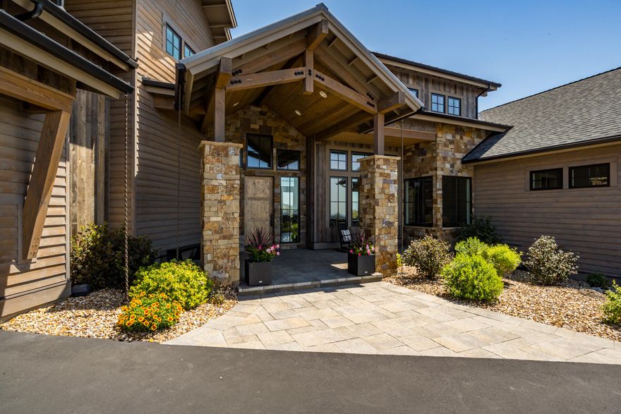 Experience the perfect blend of elegance, comfort & breathtaking views in this thoughtfully crafted 4-bedroom, 3.5 bath 3963 SF home located in the serene & amenity-rich community of Brasada Ranch. Step inside to find white oak hardwood floors, vaulted ceilings & a light filled open layout designed for both everyday living & entertaining. The main floor features a well-appointed primary suite, office, gourmet kitchen outfitted with high end Dacor appliances, quartz countertops, a spacious island & generous walk in pantry.  Wine enthusiasts will love the 300-bottle capacity wine cellar. The living room features an accordion door system that opens to a spectacular outdoor deck with built-in fire pit-perfect for enjoying the common area canyon space & expansive valley views. The upper level includes 2 en-suites bedrooms, a family room which includes the Bang Olufsen TV & surround sound, also a flexible bonus room ideal for crafting, sewing or working from home.