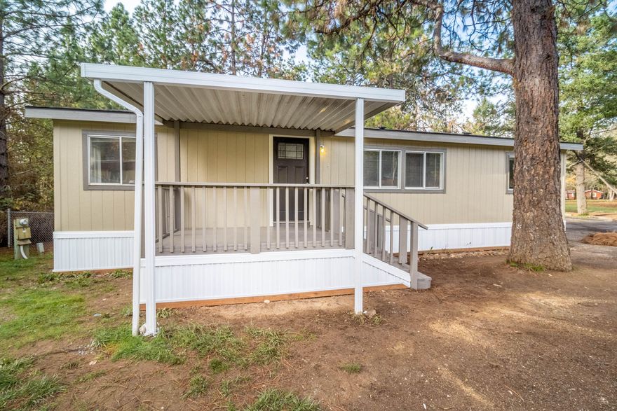 Enjoy Rural Living in a Like New Home located in a Family Friendly Park! Enjoy a cup of coffee on your Inviting Front Porch or stay comfortable in your Tastefully Remodeled Double Wide Manufactured Home with 3 Bed/2 Bath! Top to bottom remodel with NEW Roof, Plumbing, Water Heater, Laminate Wood Flooring, Light Fixtures, Sky Light, Two Tile Surround Showers with Bathtubs, Interior & Exterior Paint, and More! You'll be eager to cook in the Gorgeous Kitchen with All New Stainless Steel Appliances and Attractive Countertops with Tile Backsplash! Master Bedroom and Bath have Walk-In Closet, Extra Large Tub, and Linen Area. Home is located on perimeter of park, adjacent to a beautiful, treed property. Newer Owners are transforming this Park into a well-cared for Rural Family Friendly Park. Improvements to be expected in the future include well-maintained roads, a park-like common area, and continuation of updating the facilities and park homes!