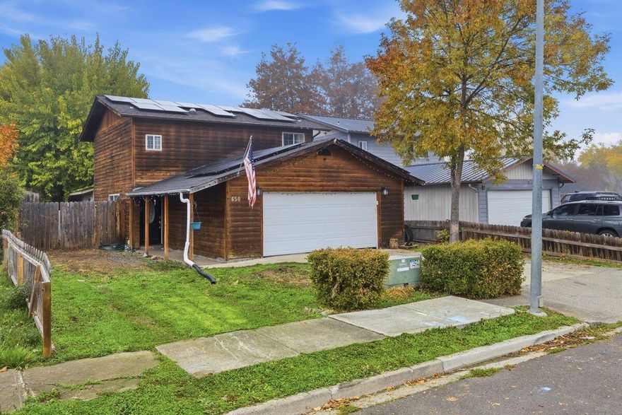 Discover this charming and versatile home—perfect as a starter residence or an income-producing property—conveniently located just minutes from downtown Eagle Point. Featuring rustic cedar siding and an inviting open floor plan. The home also offers warm character paired with practical updates. The kitchen includes laminate wood flooring, a stylish tile backsplash, and a comfortable flow into the main living area.The living room opens onto a spacious enclosed sun porch, providing a bright, relaxing space with views of the private, fenced backyard filled with mature trees. Upstairs, you'll find three bedrooms along with a well-appointed full bathroom. Additional highlights include an efficient HVAC system and an added solar power system for energy saving. This home is move in ready.