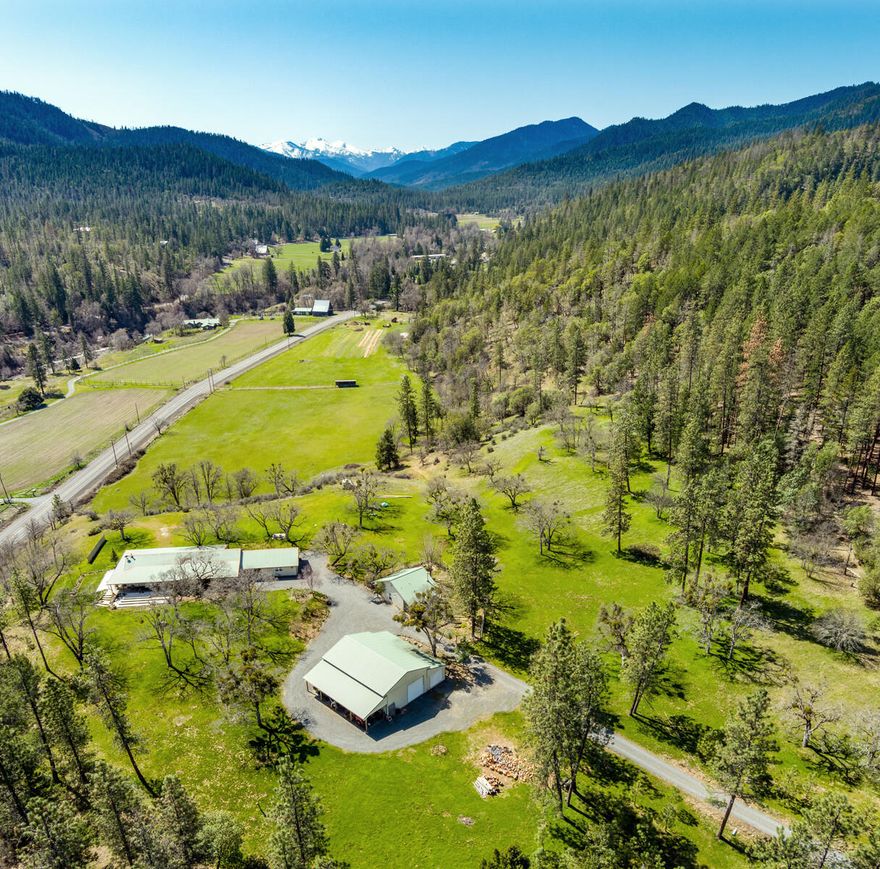 Enjoy the panoramic views from your own 110 private acres, bordered by BLM land, with over 1/3 mile of Applegate River frontage. Two large pasture areas with a combined 34 acres of Applegate River irrigation rights. Ranch style home built in 2002 sits on a knoll overlooking the red buttes with expansive valley views. This 2200 SF 3 bed/ 2 1/2 bath house has generous porches on three sides designed for ultimate indoor/ outdoor living and designed to maximize the views. Sunny cook's kitchen with ample counter space, generous pantry, and dynamite view from the kitchen
sink. Covered breezeway leads to an oversize 2 car garage. Sweet detached 576 SF guest cottage with vaulted ceiling, surrounded by pollinator gardens. Large RV garage/ shop space with plenty of room for projects, toys, or storage. With excellent sun exposure, this property would be great for vineyards, horses, hayfields, or a serene natural retreat.