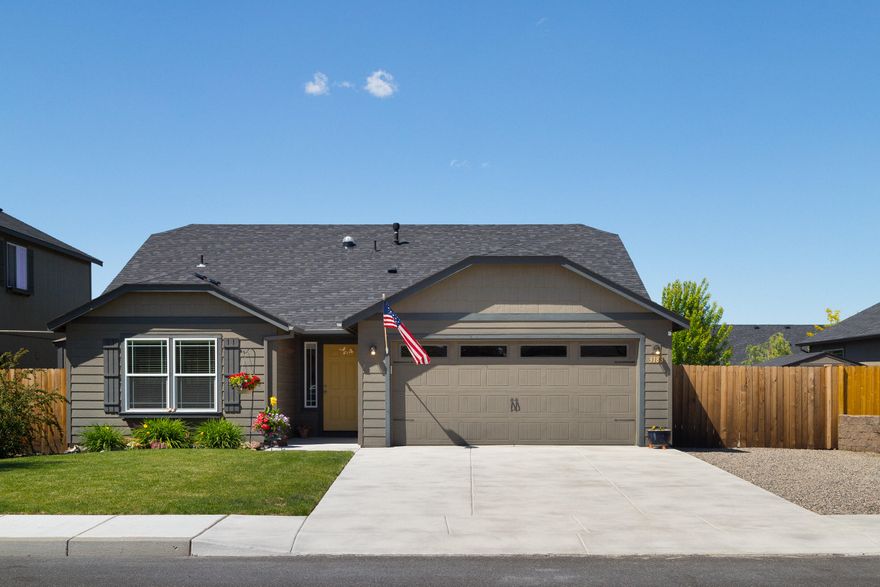 Extremely well cared for home. Large lot with 14' wide RV graveled parking area. Owner has upgraded this home to include a Gas Fireplace, Central Air, beautifully landscaped back yard with sprinkler system. Edgewood floor plan features vaulted Great Room and a vaulted ceiling in the Master Bedroom. Breakfast Bar at the island. Stainless appliances in the kitchen. Includes washer/dryer. Plant shelves for decorating, Double Master walk in closets. No step-in from front or garage. Master has step in shower and double vanity. Finished attached double car garage with a man door to the side yard. Turn Key and ready for new owner. Driveway resurfaced. Plumbed for gas at cook stove & patio BBQ area.