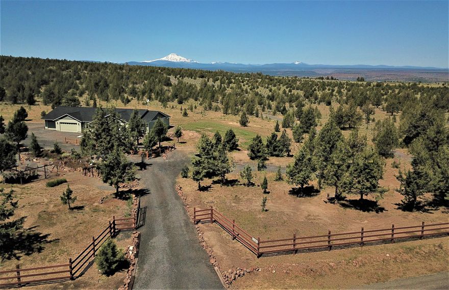 Amazing custom built home inside & out sitting on 2 full acres with panoramic Cascade mnt.views and territory/valley. Road side is fenced & gated w/huge circular driveway to accommodate friends  family & RV's. From the large  inviting entry,to the office/craft room, to the custom gourmet kitchen, to eating area w/bay window, to the panoramic views out the large West facing windows, this home has it all. 2 guest bedrooms w/shared 3 pc. bathroom w/tile accents and quartz counters. The large Master has a slider to view the mtns. from bed & step out to the spacious back yard w/4 pc. bath with step-in show & jacuzzi tub plus large walk-in closet. AND so much more. See attached Amenities Sheet.