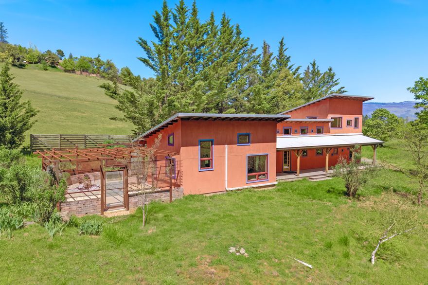 Discover this bright and modern home tucked away on 5 private acres,
just minutes from Talent and Ashland. Expansive, sun-drenched fields are surrounded by mature oaks and conifers. Already in place are two fenced gardens, raised beds, a generous workshop, and thriving fruit trees. This property boasts extensive water resources for hobby farming
and animals, including a seasonal creek, rainwater collection, and 43,000 gallons of storage. Inside, a custom-built masonry heater anchors the living space, complemented by large south-facing windows that invite warmth and natural light. The primary suite, renovated in 2023, offers a relaxing, airy retreat with scenic views and a luxurious shower. Two versatile second-floor bedrooms, ideal as home offices, overlook the valley. Superior thermal performance is provided by insulated SIP panel framing. A versatile bonus cabin is ready for your
creative projects or personal retreat. Enjoy the best of urban convenience and rural tranquility.