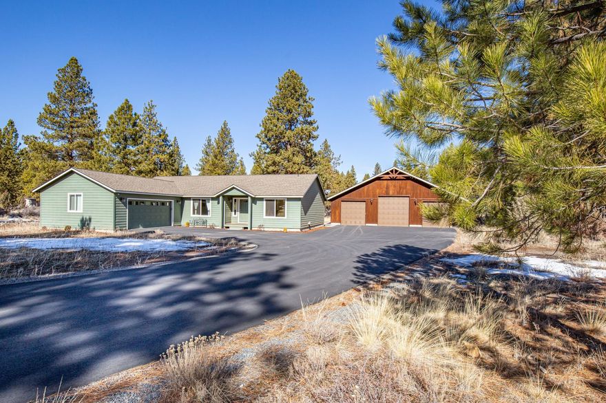 Welcome home to this private, beautifully treed 2.62-acre oasis in a well-established neighborhood, where the fast-pace of the city feels far away. Immaculate, lovingly maintained, single-story home offers 1,940 square feet of well-designed living space in a fantastic layout with 3-bedrooms and 2-baths, vaulted open great room, bright kitchen featuring new quartz countertops, and large dining area. Generous windows bring the outside in and create a warm and welcoming place for family and friends to gather.  With plenty of room to roam, this special property offers a greenhouse, hot tub, low-maintenance landscaping, and large composite deck perfect for taking in the Central Oregon sunshine. Revel in the abundant storage with attached 2-car garage and additional 50' x 50' shop with 3-bay doors and 50-amp service.  Celebrate the Pacific Northwest lifestyle from your serene retreat, just minutes amenities and recreation.