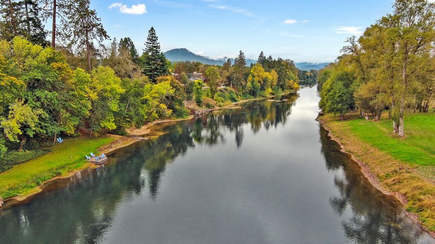 1.16 park-like acres on the bank of the Rogue River with custom single level home which captures stunning views of the river from the living & family rooms, den and master suite. This gem has low bank river frontage with walking path to a sprawling lawn at the water's edge complete with a boat dock!  Enjoy the soothing sound of Sand Creek from the patio as it meanders along the edge of the property. Enter the home and immediately take in the beautiful river view from the picture windows in the living room.  The master suite has French doors leading to the hot tub area and patio.  There is a spacious office, open family room and billiard room with den which could be a third bedroom.  The property welcomes you thru a gated entry with beautiful lawn, majestic trees and mature landscaping. That's not all!  The property is ready for your toys with a large detached shop, RV hookups and storage shed!  in-ground sprinkler system, paved drive and end of the cul-de-sac privacy!