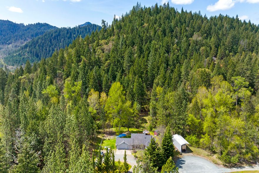 Own your own mountain and Creek in the Backyard! Gorgeous 3bd/2 ba., Home on Private 7.52ac with Rv covered parking with hookups, storage buildings with backup power generator.  Enjoy sliding glass doors that lead to the Gazebo/deck from the Living room & Master bedroom, Vaulted Ceilings, Ceiling fans, Heat pump, Fireplace,  Tile Ceramic flooring, Brkfst nook, wet bar and appliances included.  Master Bedroom w/ Lg. Sit down shower/tub, Walk-in closet, Nicely landscaped Lg. Front & back yards with sprinkler system, Circle driveway, Three car garage, RV Parking, quiet and beautiful mountain views. Book your tour.  All pictures and videos property of hommati.